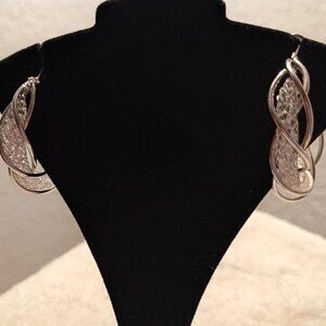 Gold hoop earrings with a twisted design and clear Crystal